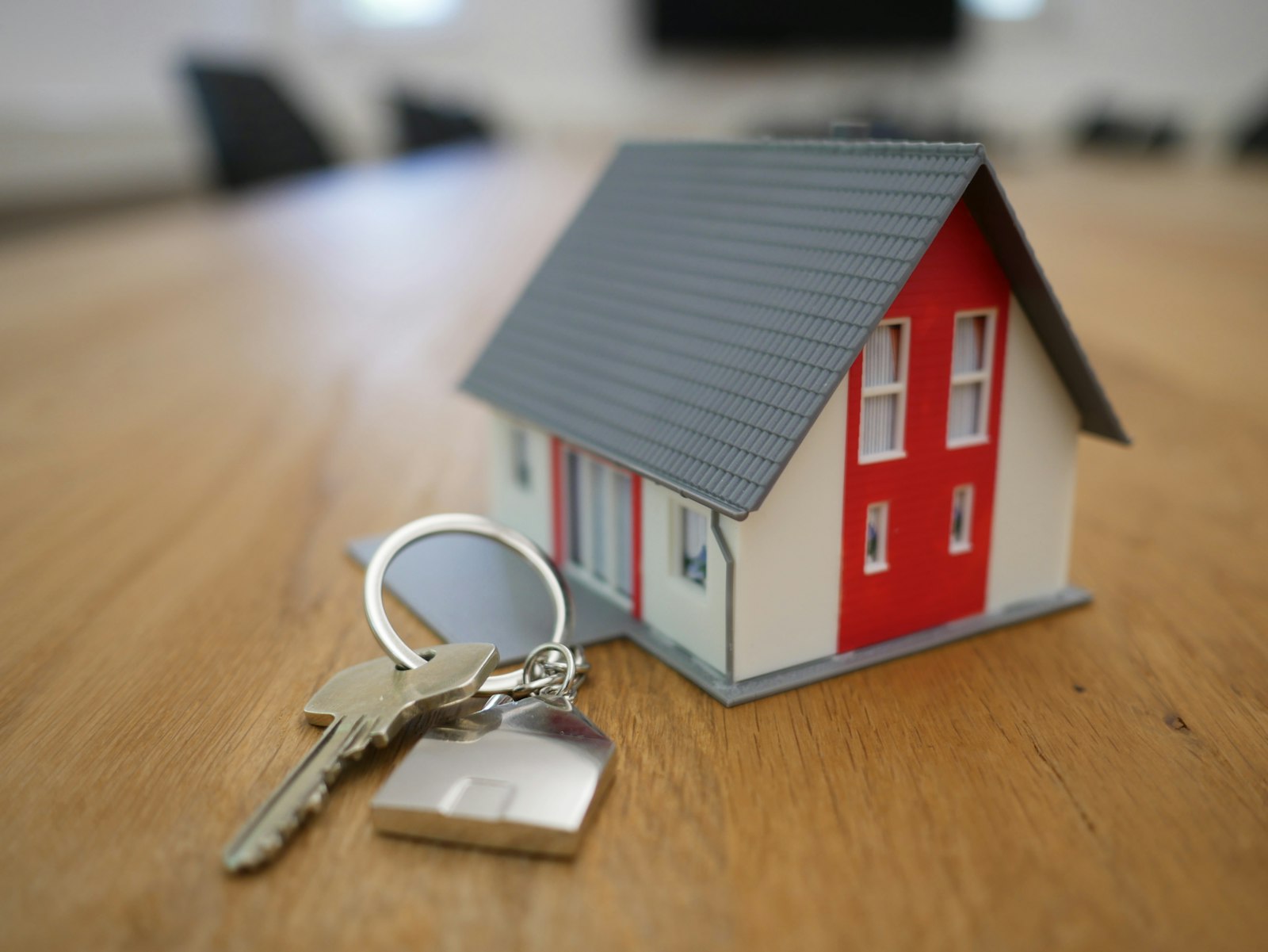 House keys resting beside a model home